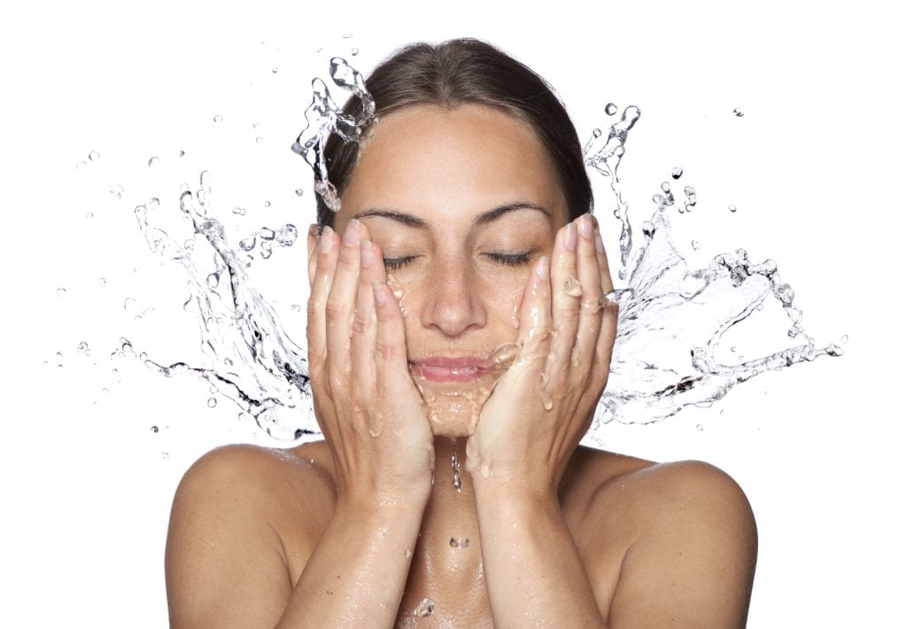Beautiful wet woman face with water drop