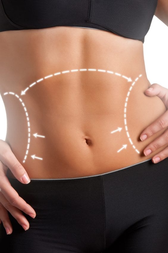 Closeup of a fit woman's abs isolated on a white background