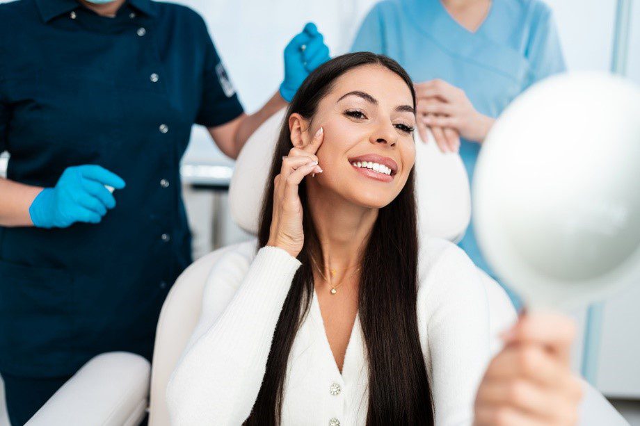 Woman admiring her skin after a facial treatment at ASC