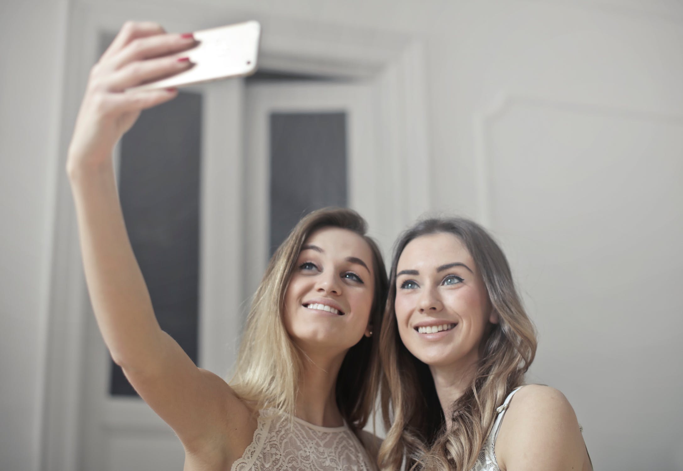 two women taking selfies