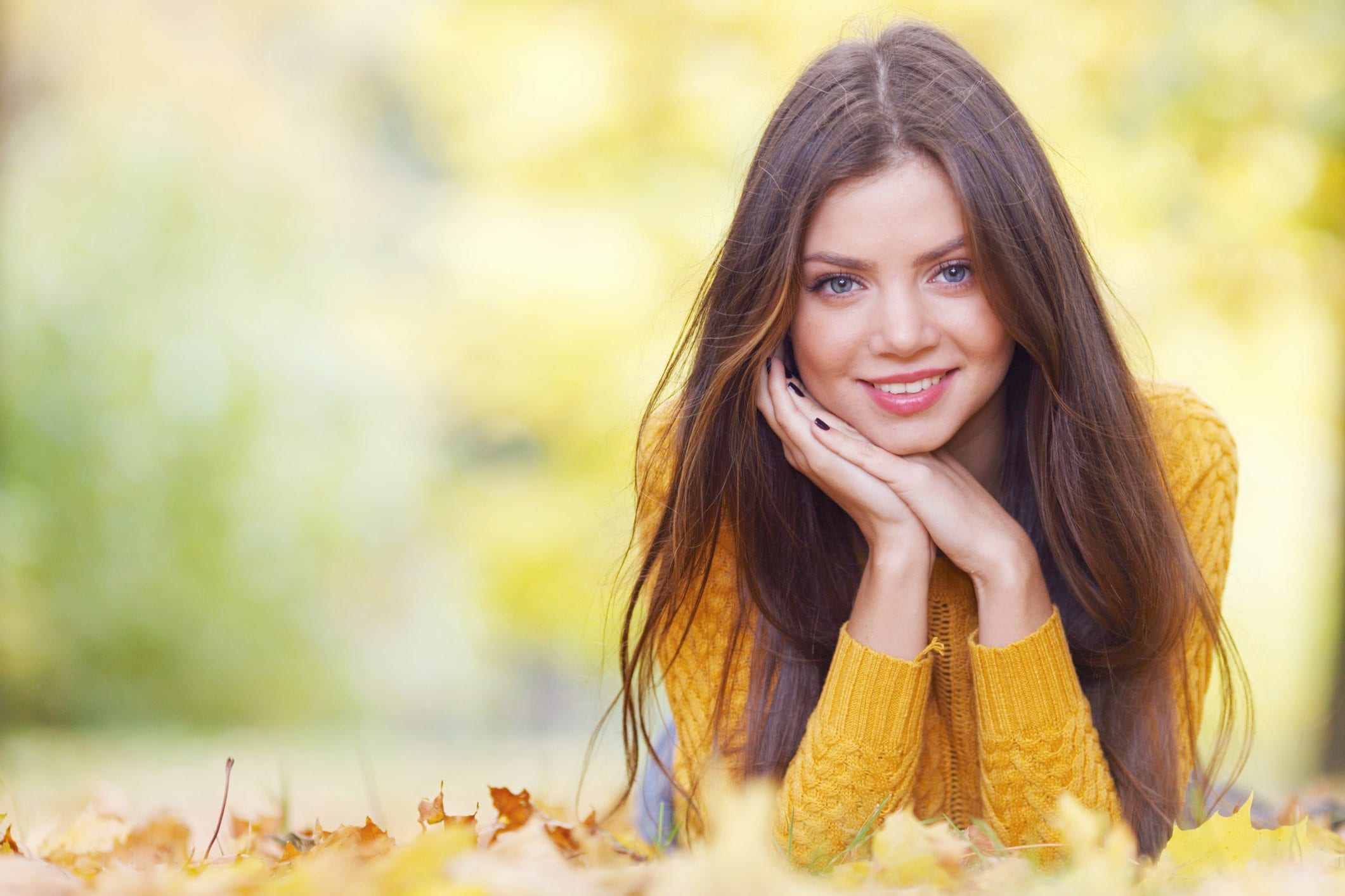 Brunette woman laying in autumn park