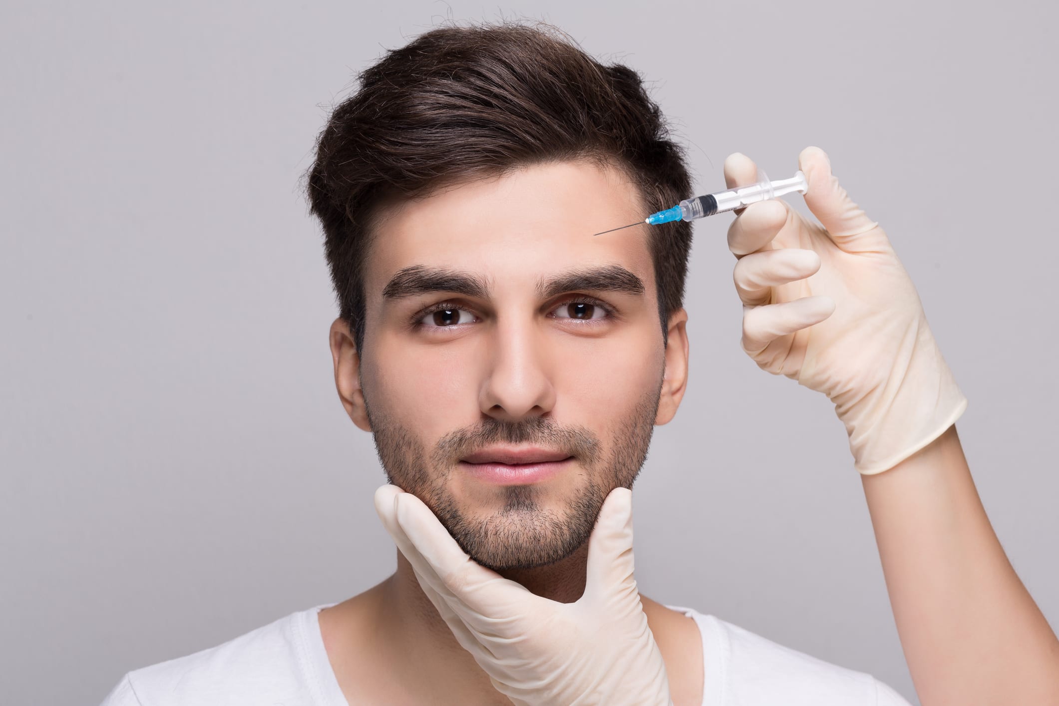 Filler forehead injection for male face in beauty clinic