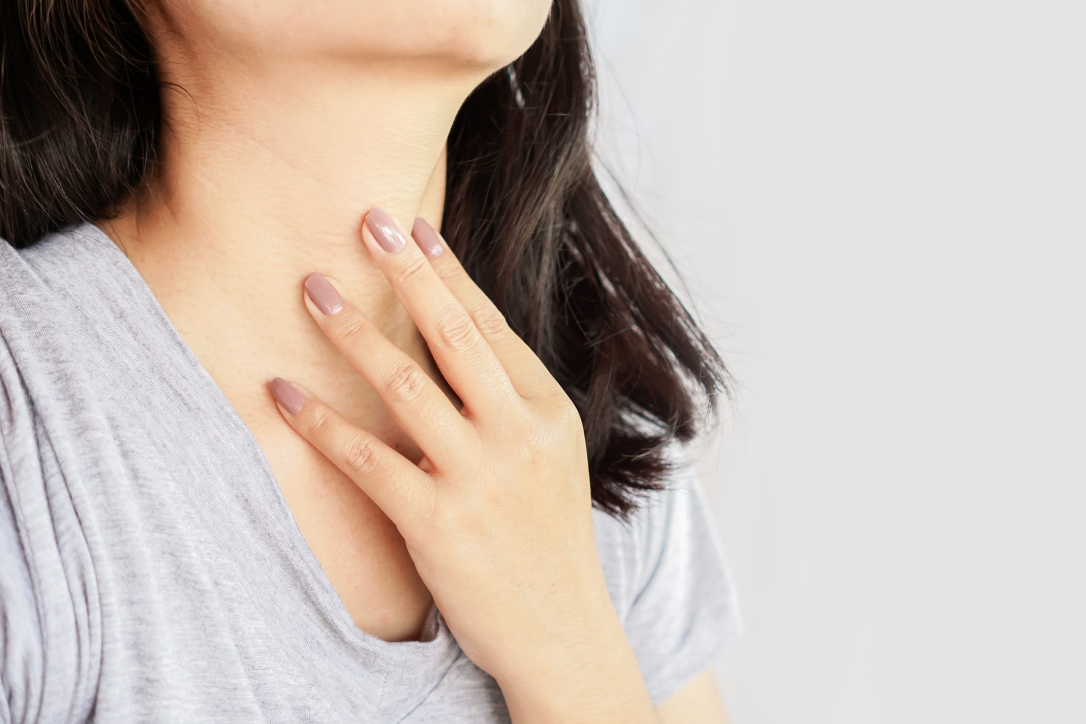 Woman with hand on her neck