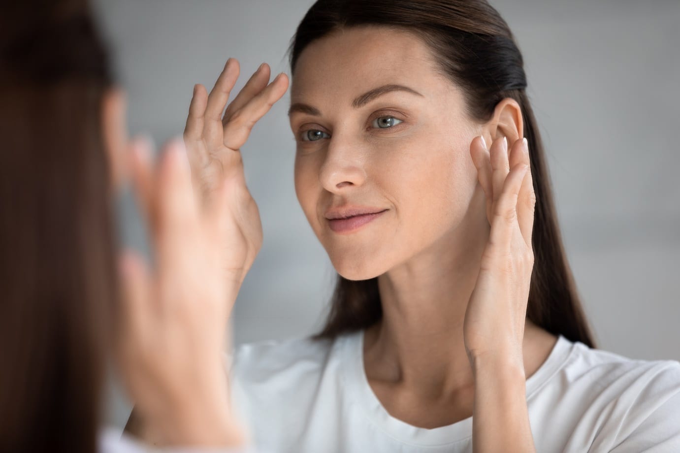 woman looking in mirror