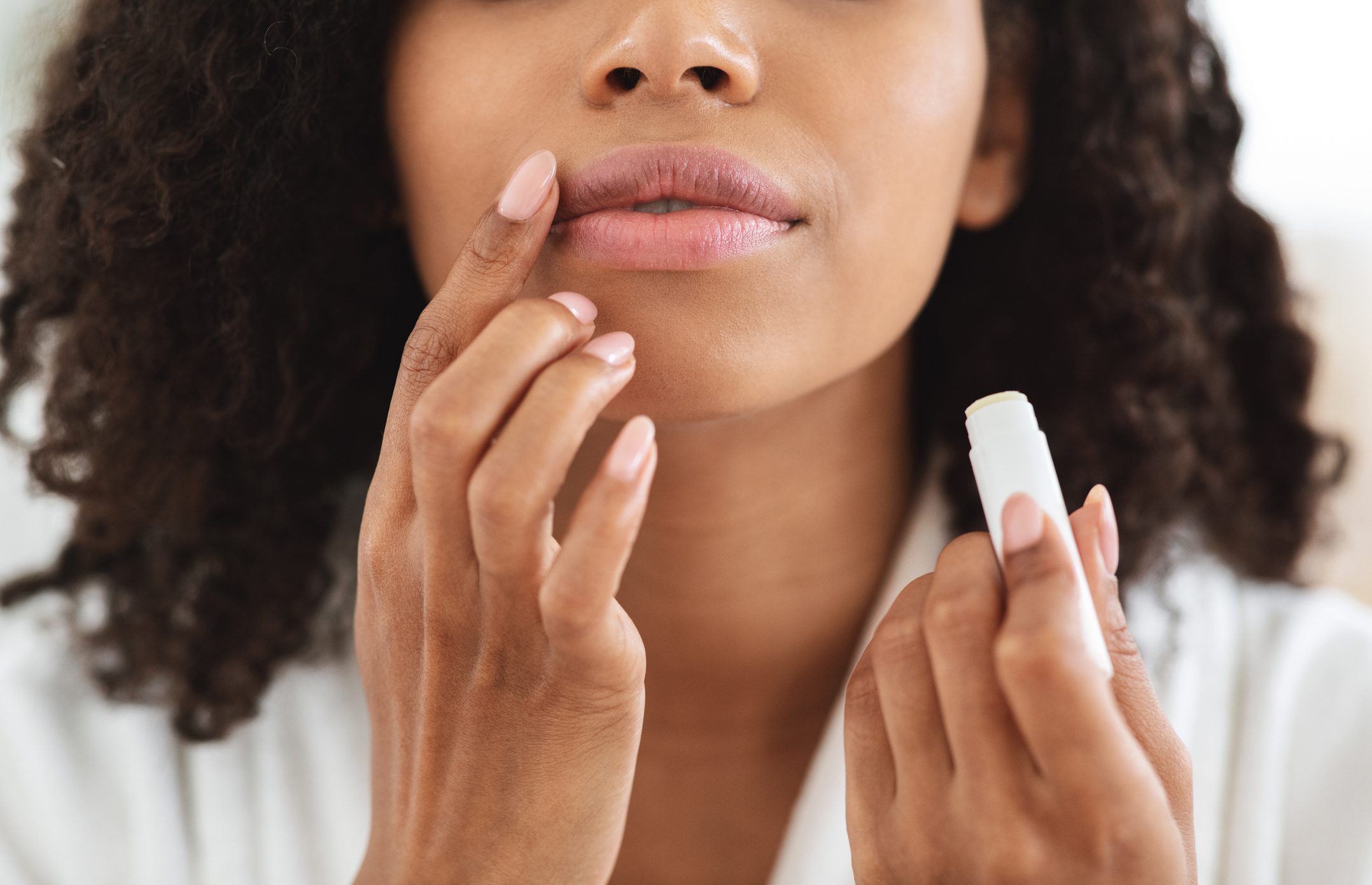 Woman applying moisturising chapstick on lips