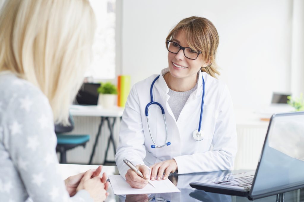 Female medical practitioner at cosmetic treatment consultation