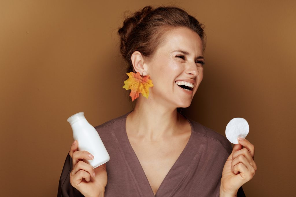 Woman doing skincare routine in autumn