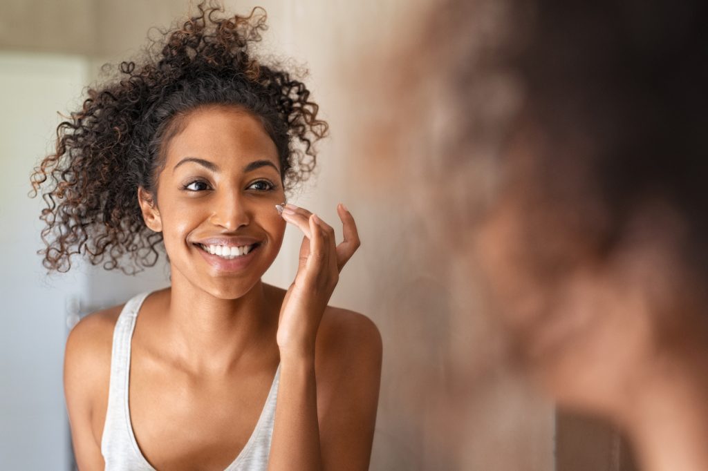 Woman completing skincare routine