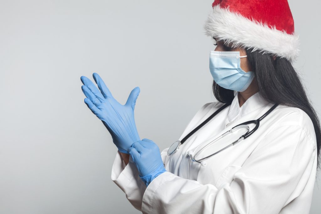 Female cosmetic practitioner with Christmas hat