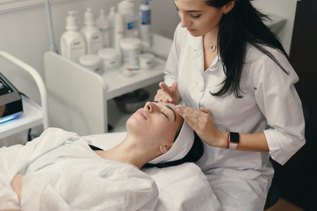 A woman receiving a professional facial treatment