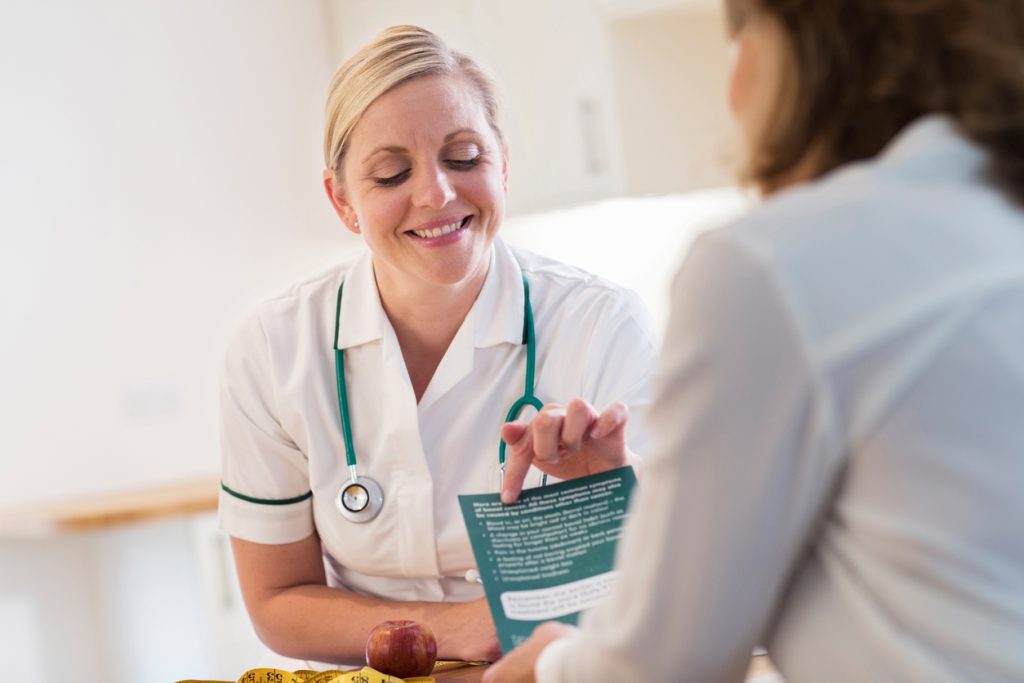 Cosmetic doctor showing a patient a leaflet about sleep about her procedure