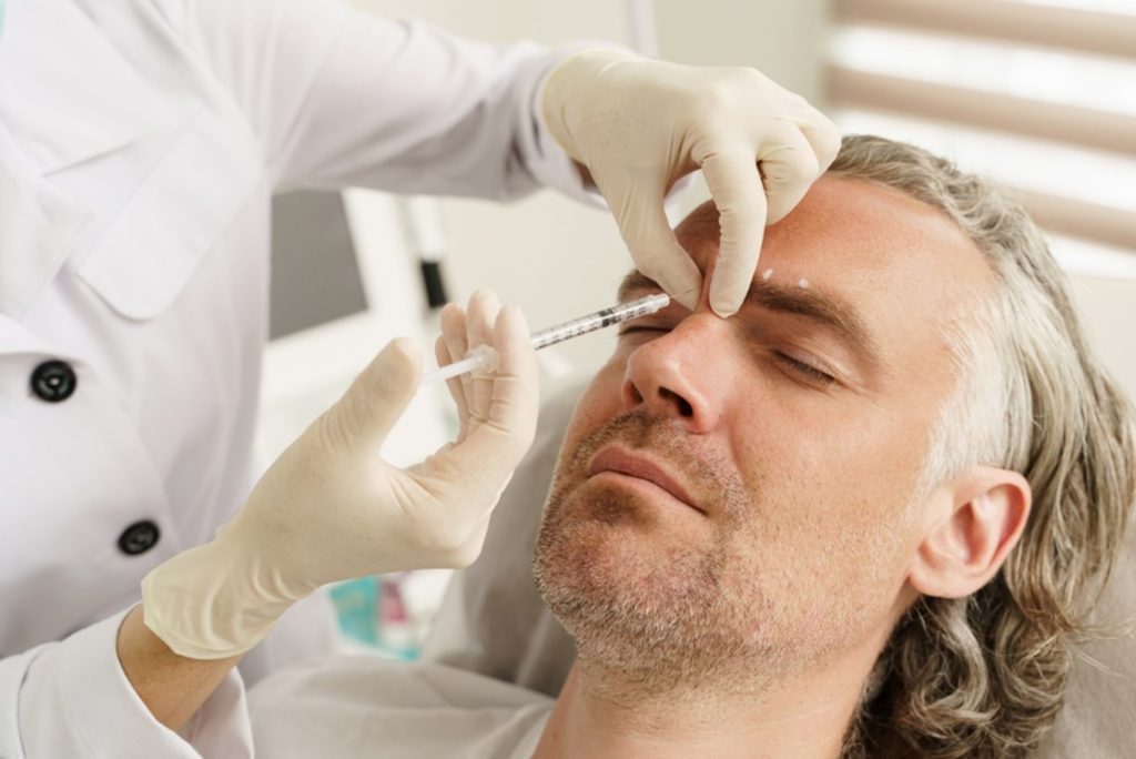 Man having dermal fillers injected into the forehead