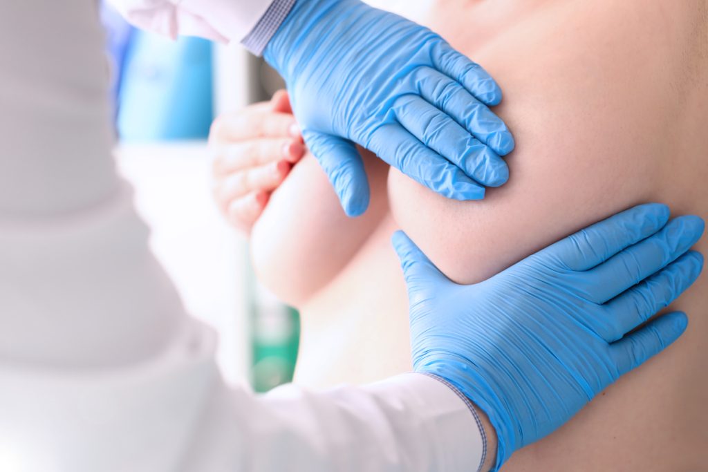 Surgeon checking the breast before a breast enhancement