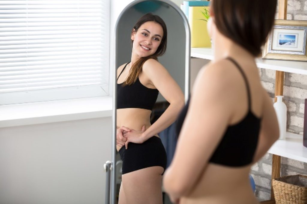 Woman looking at herself in the mirror