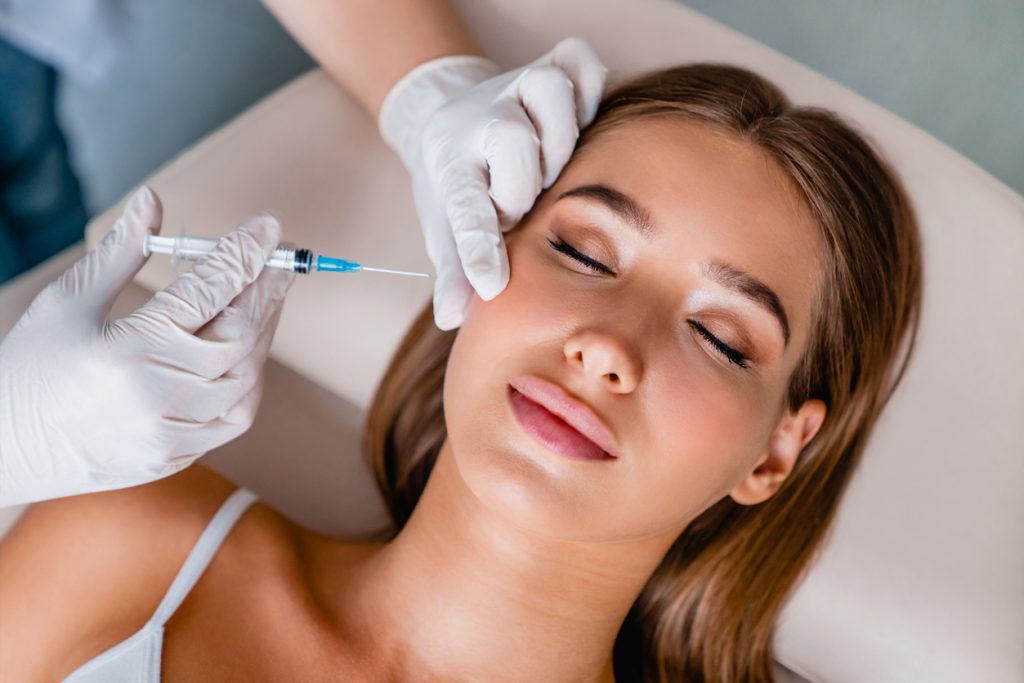 Woman having fillers in her cheek