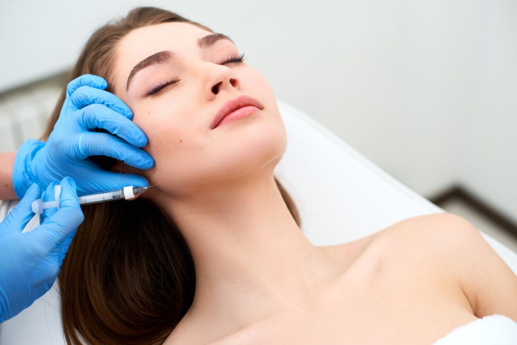 Woman having facial fillers in her jaw