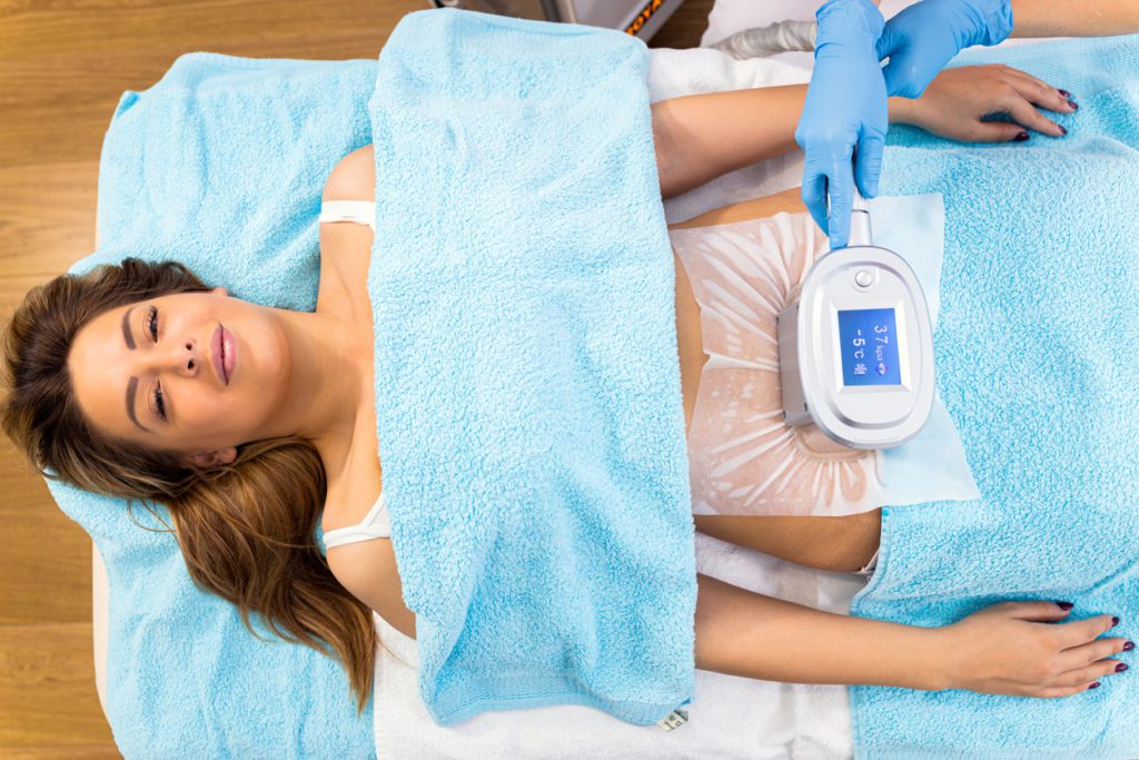 A woman going through  a fat freezing treatment