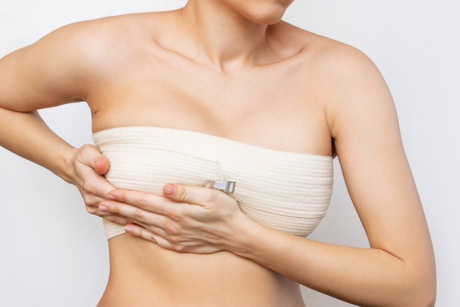 A woman recovering from breast reduction surgery