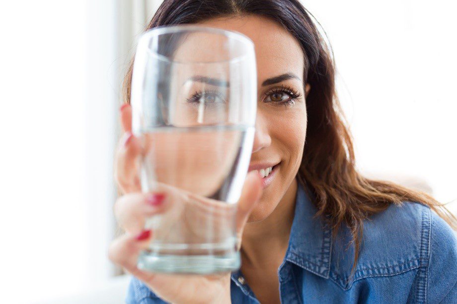 Woman drinking water smiling