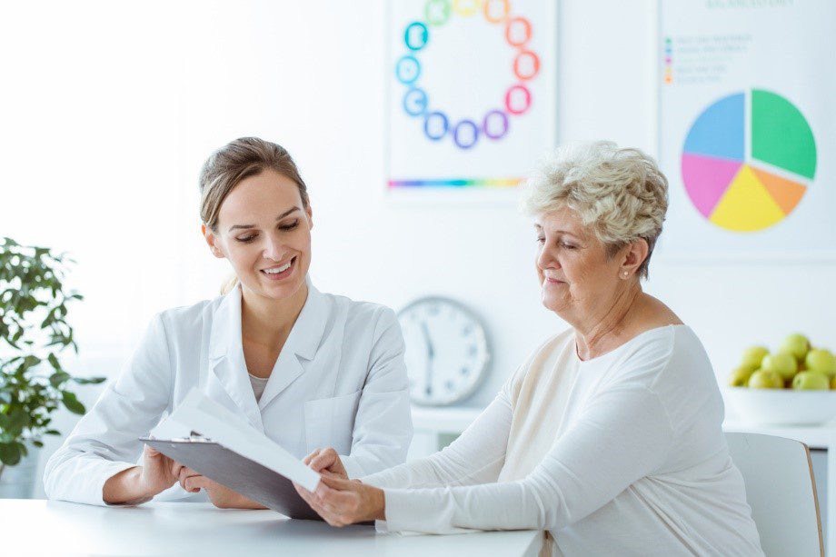 Smiling woman looking at her fat freezing options in a clinic