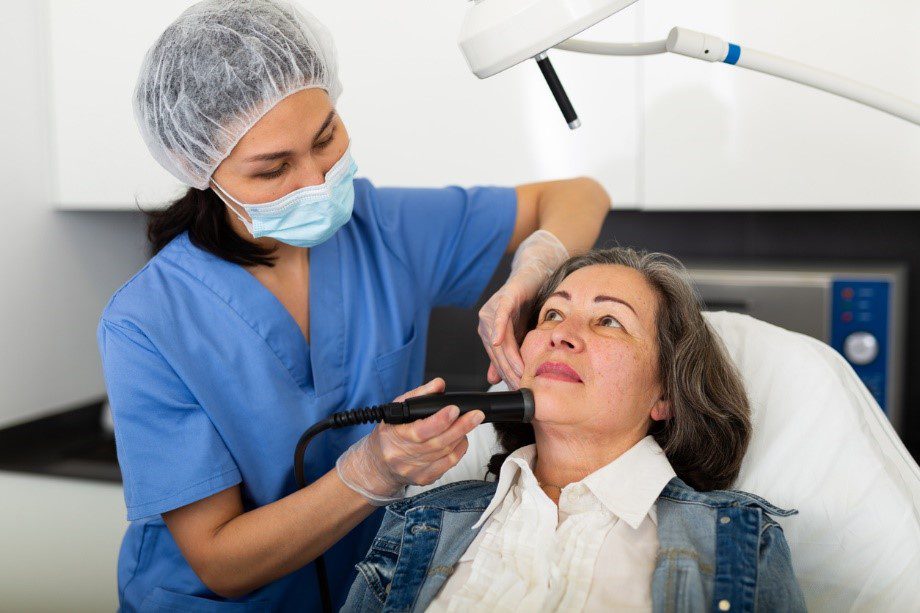 Woman having fat freezing treatment on face