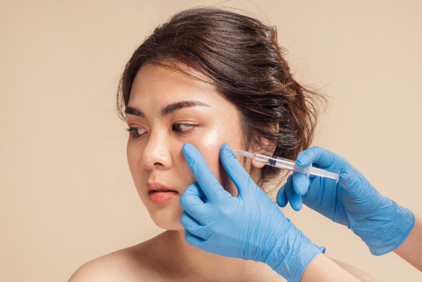 asian woman having dermal cheek injections