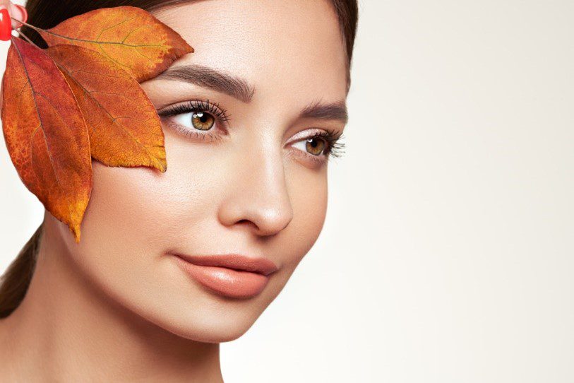 woman smiling with a leaf on her head