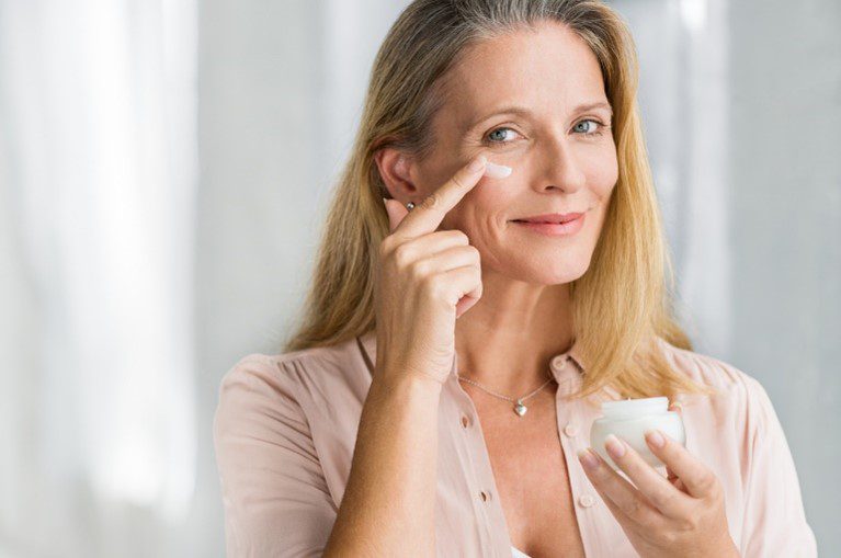 woman smearing products on face