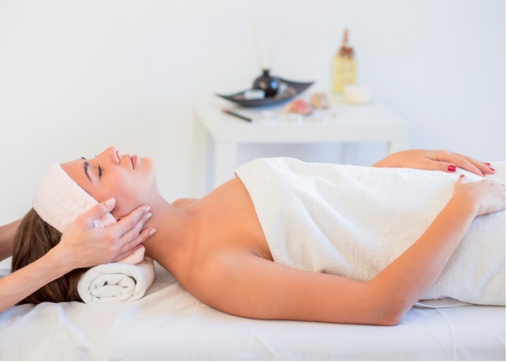 A person lying down on a massage table